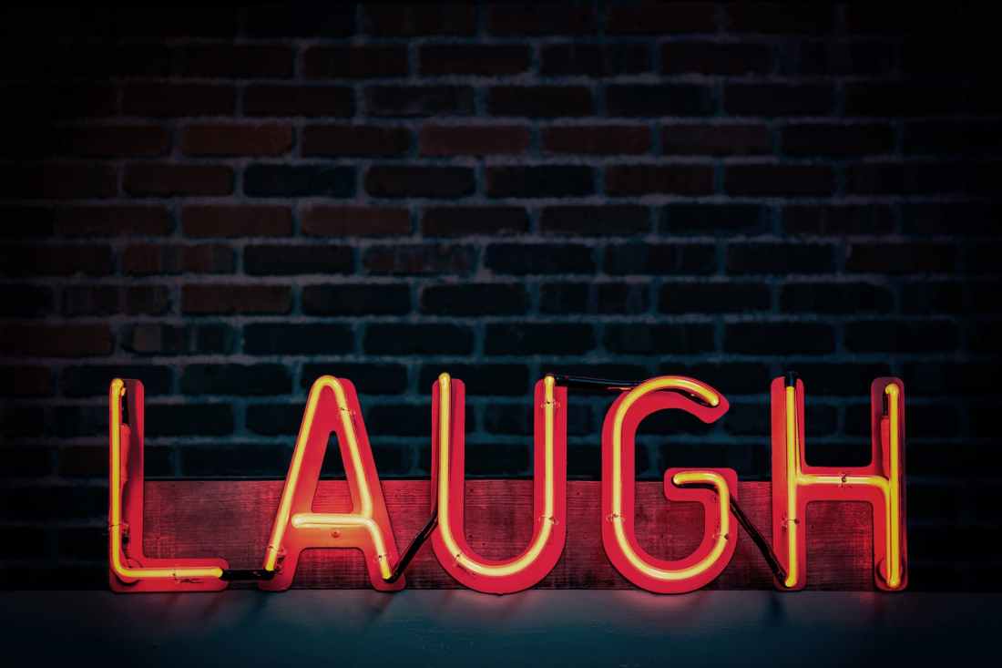 laugh neon light signage turned on